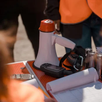 Focus on teamwork and safety with visible protective gear and communication tools.